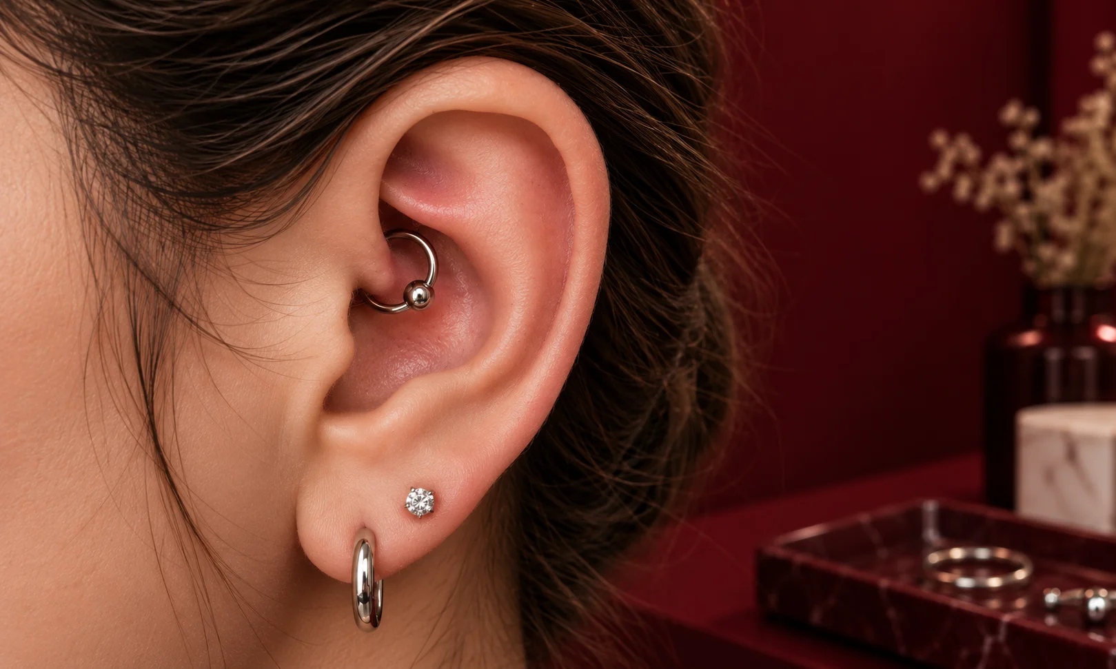 close up of daith piercing ring in inner ear fold to avoid early jewelry swap complications