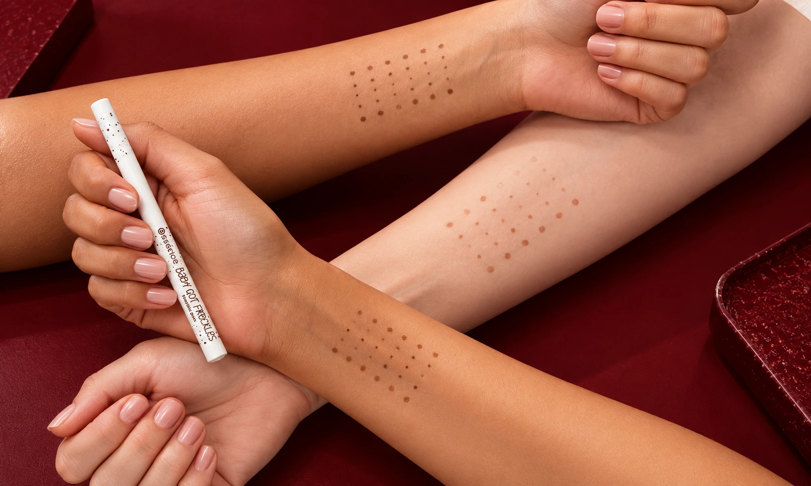 A close-up photograph shows three arms with different skin tones