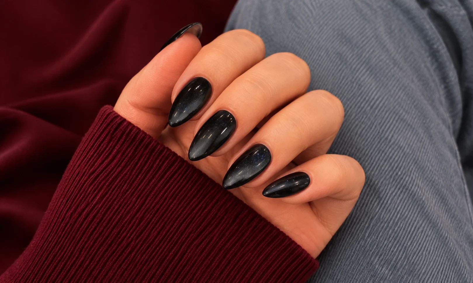 Black cat eye nails with silver shimmer